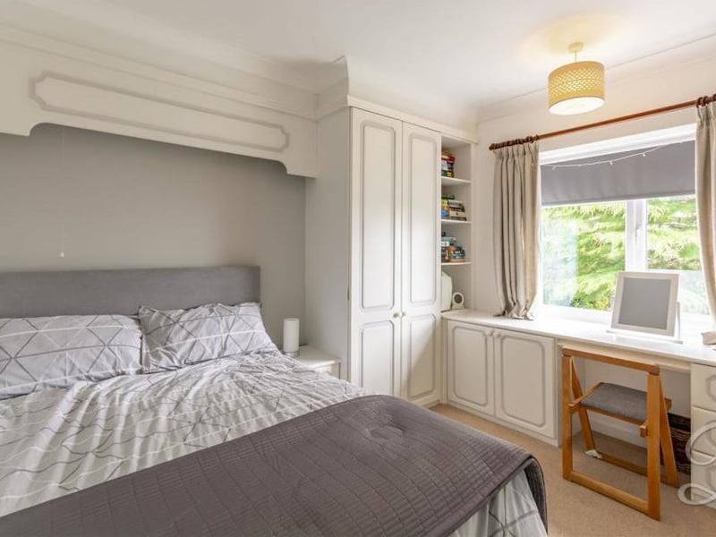 Another comfortable bedroom. A carpeted floor, fitted wardrobes and access to an en-suite bathroom.
