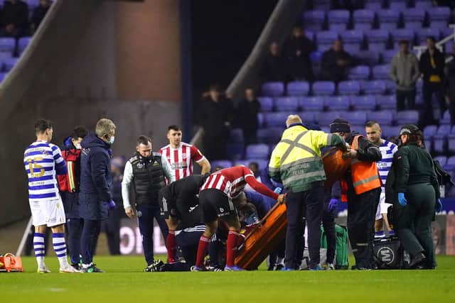 Sheffield United's John Fleck is placed on a stretcher during the Sky Bet Championship match at the Madejski Stadium, Reading.  John Walton/PA Wire.