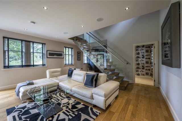 The stylish cinema room boasts a wet bar and a contemporary floating staircase with wide oak treads and glass panel balustrade, as well as its own WC.