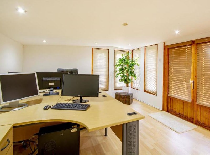The annexe even has its own office. It has laminate flooring, windows and patio doors leading outside.