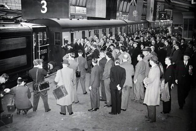 Excitement at Sheffield Victoria Station as the first electric train arrives at the inauguration of the electric rail line on September 14, 1954