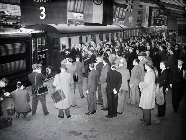 Excitement at Sheffield Victoria railway station as the first electric train arrives at the inauguration of the electric rail line on September 14, 1954