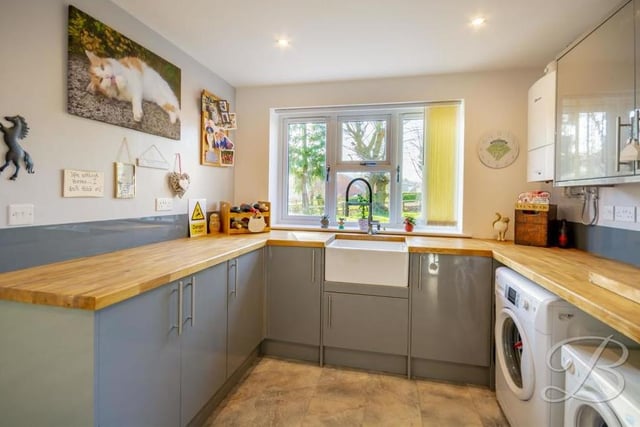 Sure to come in handy is this U-shaped utility room. It boasts modern glass grey units, a Belfast sink with mixer tap over, plus space for a washing machine and tumble dryer.