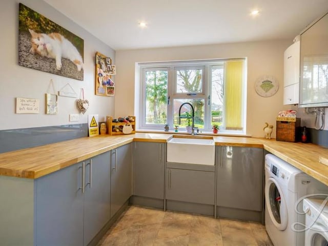 Sure to come in handy is this U-shaped utility room. It boasts modern glass grey units, a Belfast sink with mixer tap over, plus space for a washing machine and tumble dryer.