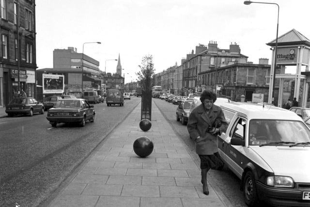 Community art - large balls painted black were set into the central reservation in Edinburgh's Leith Walk, April 1990.