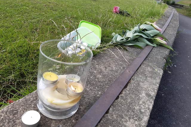 Candles in tribute to the man who died in Crookes Valley Lake by the side of the water