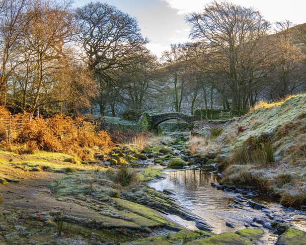 The picturesque Easter Gate Bridge, also known as Close Gate Bridge, an ancient packhorse bridge on the Marsden Moor Estate close to Standedge Tunnel shot on a cold frosty morning
