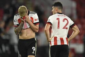 Sheffield United's Oliver McBurnie, left, and John Egan react at the end of the Premier League match between Sheffield United and Wolves at Bramall Lane. (Peter Powell/Pool via AP)