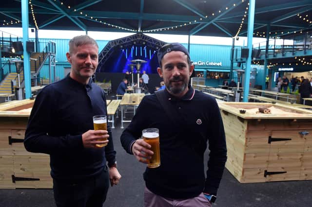 Steven Thompson, left, and Michael raise a glass at the seaside venue's first night of business.