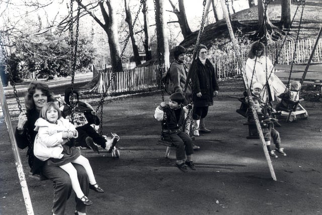 Families having fun on the swings in Chelsea Park, Sheffield, February 16, 1990