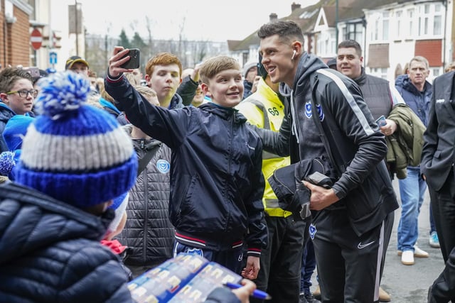 These Pompey fans greet the players on their arrival at Gillingham on New Year's Day. Hang on a minute, that young fan looks familiar!