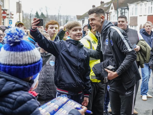 These Pompey fans greet the players on their arrival at Gillingham on New Year's Day. Hang on a minute, that young fan looks familiar!