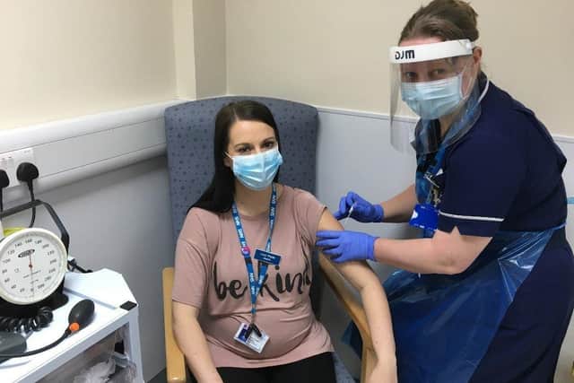 Lucy Pryde, Specialist Midwife (Smoking in Pregnancy Team) at The Rotherham NHS Foundation Trust, who is expecting twins, gets her annual flu vaccination from midwife Joanne Aitken.