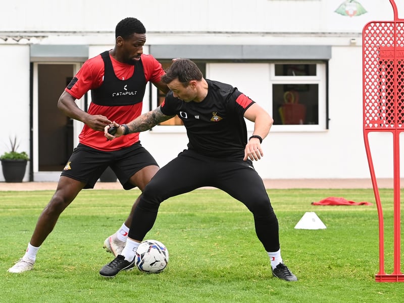 Rovers assistant boss Noel Hunt tussles with striker Omar Bogle