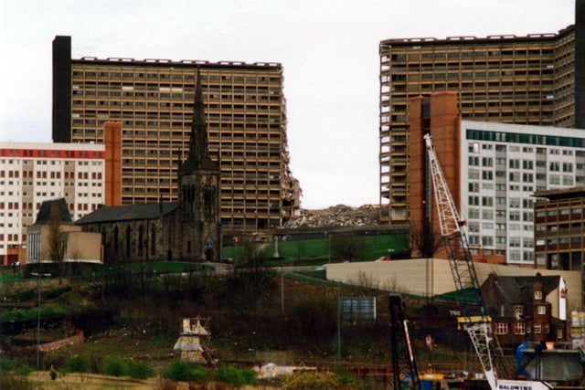 Demolition of one block of Hyde Park Flats, Sheffield, showing St John's Church, in September 1991