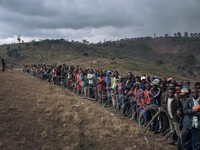 Displaced persons attend a visit by Congolese Defense Minister Aimé Ngoy Mukena