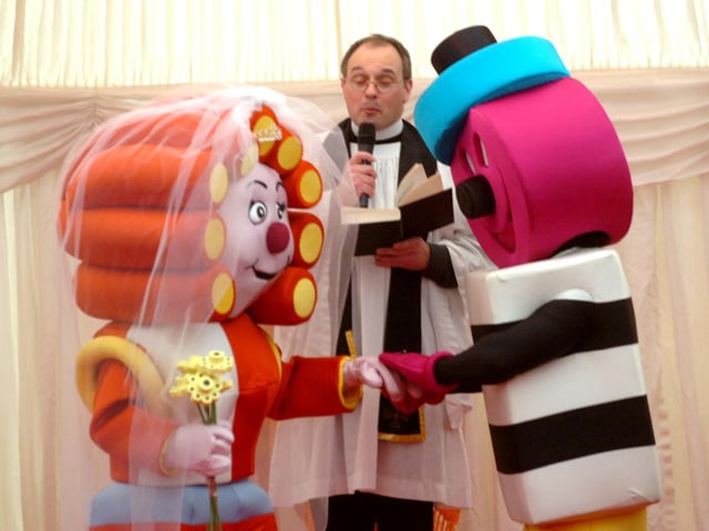 Bertie and Betty Bassett are 'married' by the Rev Sweetlove at their wedding at the Bassett's factory in 2009. The fictional wedding coincided with Bertie’s 80th birthday and Betty being chosen as the new face of Bassett’s Red Liquorice Allsorts, the first character to be introduced in those 80 years.