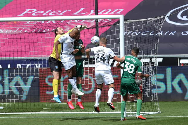 Owls keeper Joe Wildsmith punches to saftey. Pic Steve Ellis