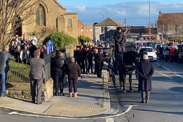 Ian's coffin is carried into church for the service as friends gathered outside.