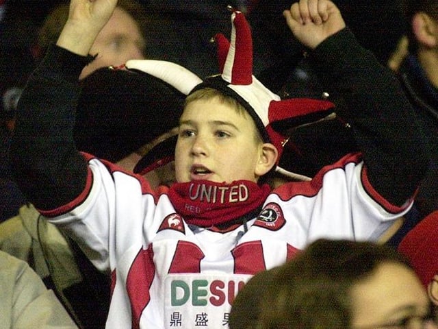 A young Blades fan celebrates after his team beat Liverpool in the Worthington Cup semi final on January 8, 2003