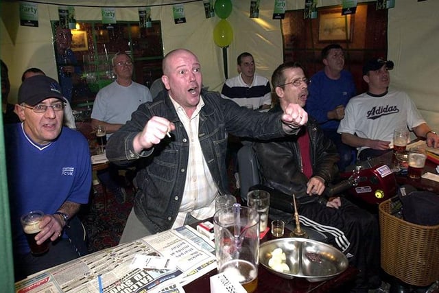 Barry Galloway (centre) cheers on his horse with other locals at the Racing Club night in the tent at The Sherwood pub, Birley Moor Road, Sheffield, March 2004