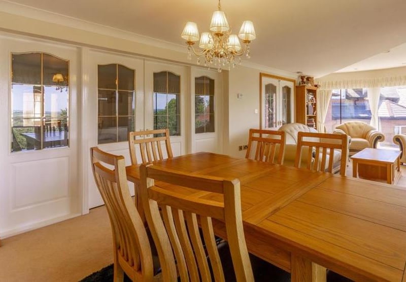 Another view of the dining room. Through the doors, it leads to other rooms in the house.