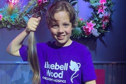 Freddie, aged 10, holding the 16-inches of hair he will be donating. Freddie has been growing his hair for four years for this fundraiser.
