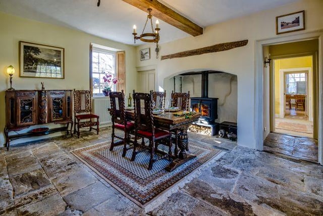 The dining room still features the original housekeeper's bells and a superb flagstone floor. This room also offers a splendid view over the garden and on to the church tower beyond