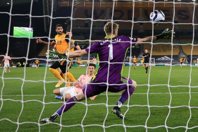 Wolverhampton Wanderers' Brazilian striker Willian José (centre left) scores the opening goal of the English Premier League football match between Wolverhampton Wanderers and Sheffield United at the Molineux stadium in Wolverhampton, central England on April 17, 2021. (Photo by Catherine Ivill / POOL / AFP) / RESTRICTED TO EDITORIAL USE. No use with unauthorized audio, video, data, fixture lists, club/league logos or 'live' services. Online in-match use limited to 120 images. An additional 40 images may be used in extra time. No video emulation. Social media in-match use limited to 120 images. An additional 40 images may be used in extra time. No use in betting publications, games or single club/league/player publications. /  (Photo by CATHERINE IVILL/POOL/AFP via Getty Images)