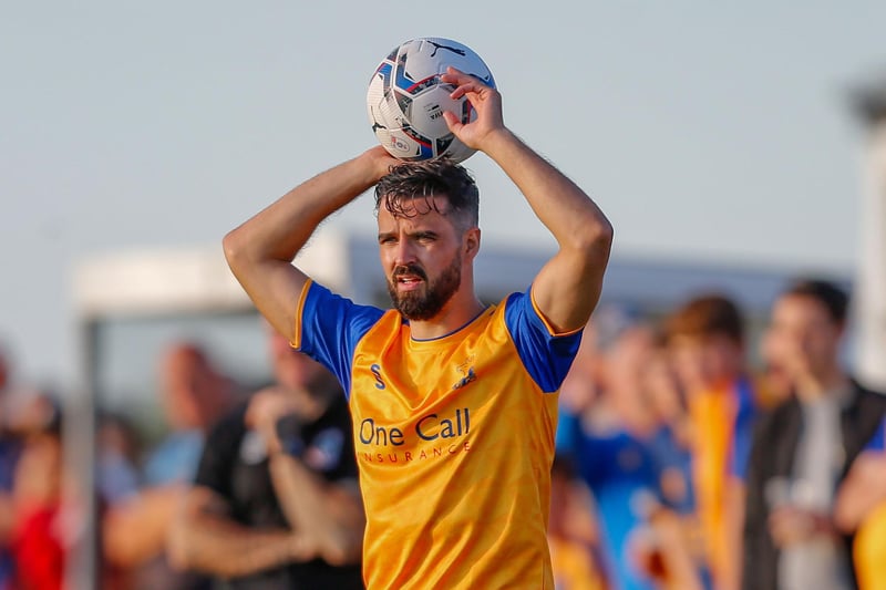 Mansfield Town's Stephen McLaughlin takes the throw-in.