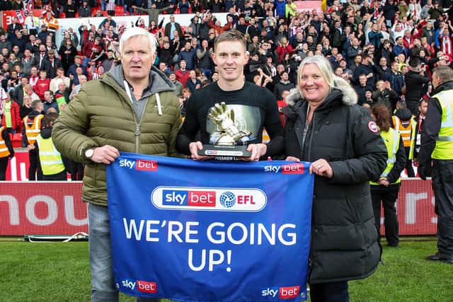 Dean Henderson celebrates Sheffield United getting promoted to the Premier League with his dad Dougie and mum Yvonne: James Wilson/Sportimage