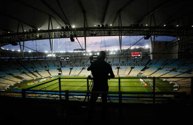 A camera crew member works in an empty stadium during a match between Flamengo and Potuguesa in Brazil in March. Photo by Bruna Prado/Getty Images