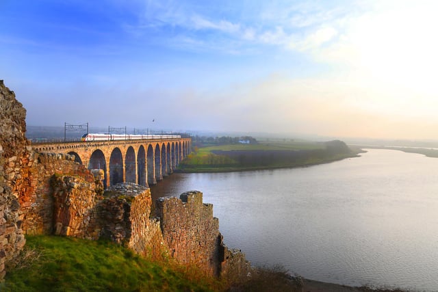 An LNER train passes over the Royal Border Bridge, which spans the River Tweed between Berwick-upon-Tweed and Tweedmouth in Northumberland, England.