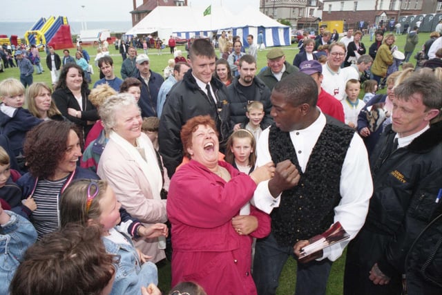 Former boxer Frank Bruno flexes his muscles for Margaret Richardson at the Monster Truck Show in May 1997.