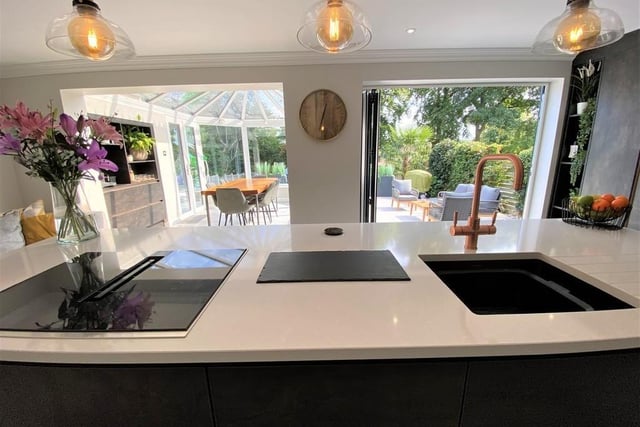 This is the view from the kitchen island out to the dining room and garden. Both the dining room and bi-folding doors get light streaming into the kitchen, making it incredibly bright in the sunshine, or lovely and cosy in the cold.
