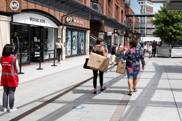 Markers on the ground show the one way system in Gunwharf Quays - as shoppers return to the outlet centre.