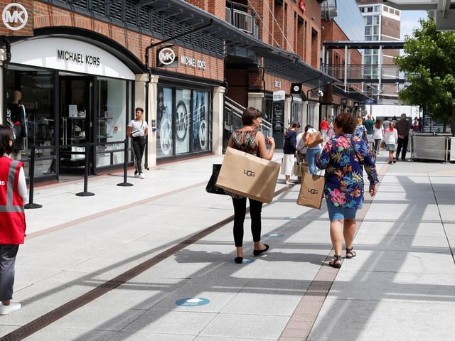 Markers on the ground show the one way system in Gunwharf Quays - as shoppers return to the outlet centre.