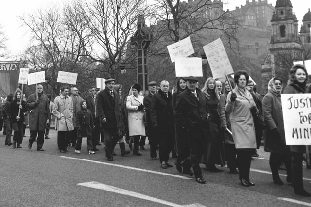 Miners and their families march along Princes Street.