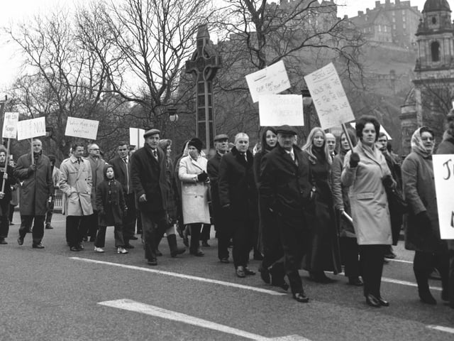 Miners and their families march along Princes Street.