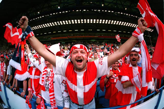 A Danish fan has the whole of Hillsborough in his hands .before their country's game aginst Croatia in Euro 96.