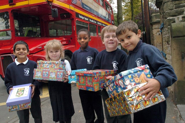 l/r: Hamza Ilyas, Rebekah Bennett, Mor'ghan Rhone, Freddie Hallows and Roshan Woods with shoe boxes for Operation Christmas Child, at Clifford C of E Infants School, Sheffield in 2005