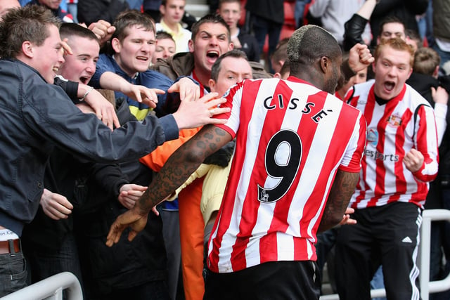 Djibril Cisse celebrates with fans after scoring his team's first goal during the Barclays Premier League match against Hull at the Stadium of Light.