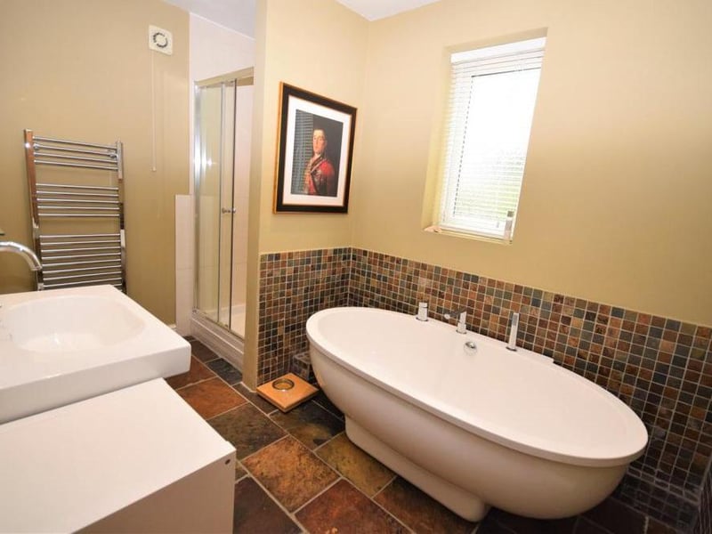 The family bathroom includes a quality suite comprising a large double-end bath and separate shower cubicle. There is  also a low-flush WC, wash basin and central-heated towel-rail.