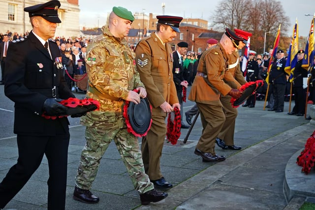 Representatives from each branch of the Armed Forces laid wreaths of poppies at the war memorial.