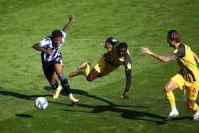 Sheffield Wednesday's Kadeem Harris (left) and Watford's Ken Sema battle for the ball during the Sky Bet Championship match at Hillsborough, Sheffield. PA Photo. Picture date: Saturday September 19, 2020. See PA story SOCCER Sheff Wed. Photo credit should read: Tim Goode/PA Wire. EDITORIAL USE ONLY No use with unauthorised audio, video, data, fixture lists, club/league logos or "live" services. Online in-match use limited to 120 images, no video emulation. No use in betting, games or single club/league/player publications.