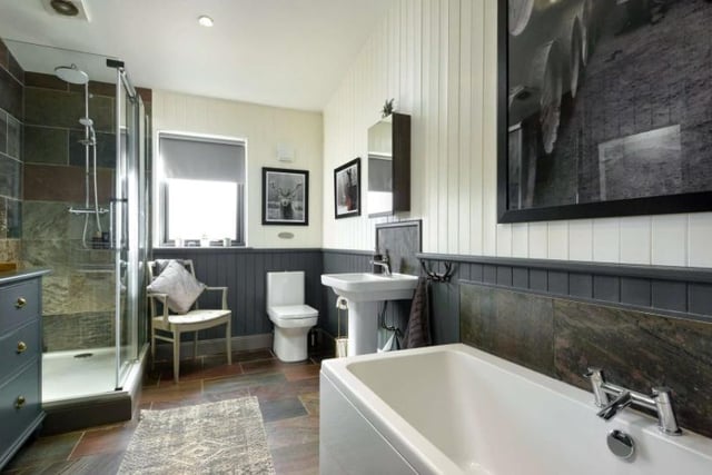 The bathrooms are beautifully designed, with separate baths and showers. This one has been designed with neutral colours of white and grey and a wonderful tiled flooring