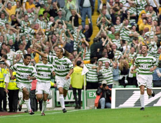 Henrik Larsson celebrates with his team-mates before scoring. Picture: SNS