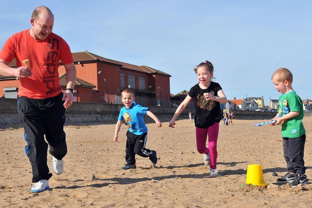 Paul, Nyle, Shannon and Ethan Storey playing a game of tig in the sunshine at Seaton Carew. It's back to 2012 for this scene.