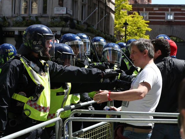 Police are confronted by protesters in Whitehall near Parliament Square. Picture: Jonathan Brady/PA Wire
