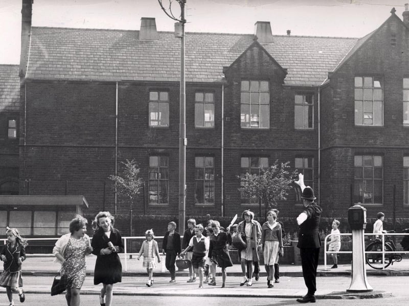 Children scamper home (with the help of a policeman) from Owler Lane School, Sheffield, July 13, 1964